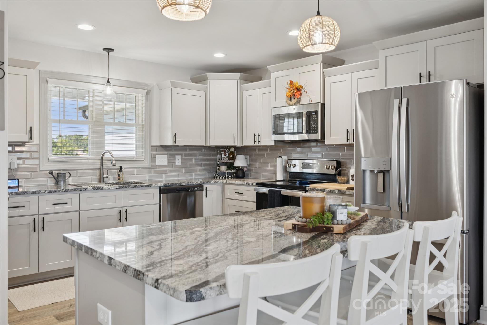 142 Alf Hoover Road Lincolnton, NC 28092 - Photo 10 of 40 a kitchen with stainless steel appliances granite countertop a stove refrigerator sink and microwave
