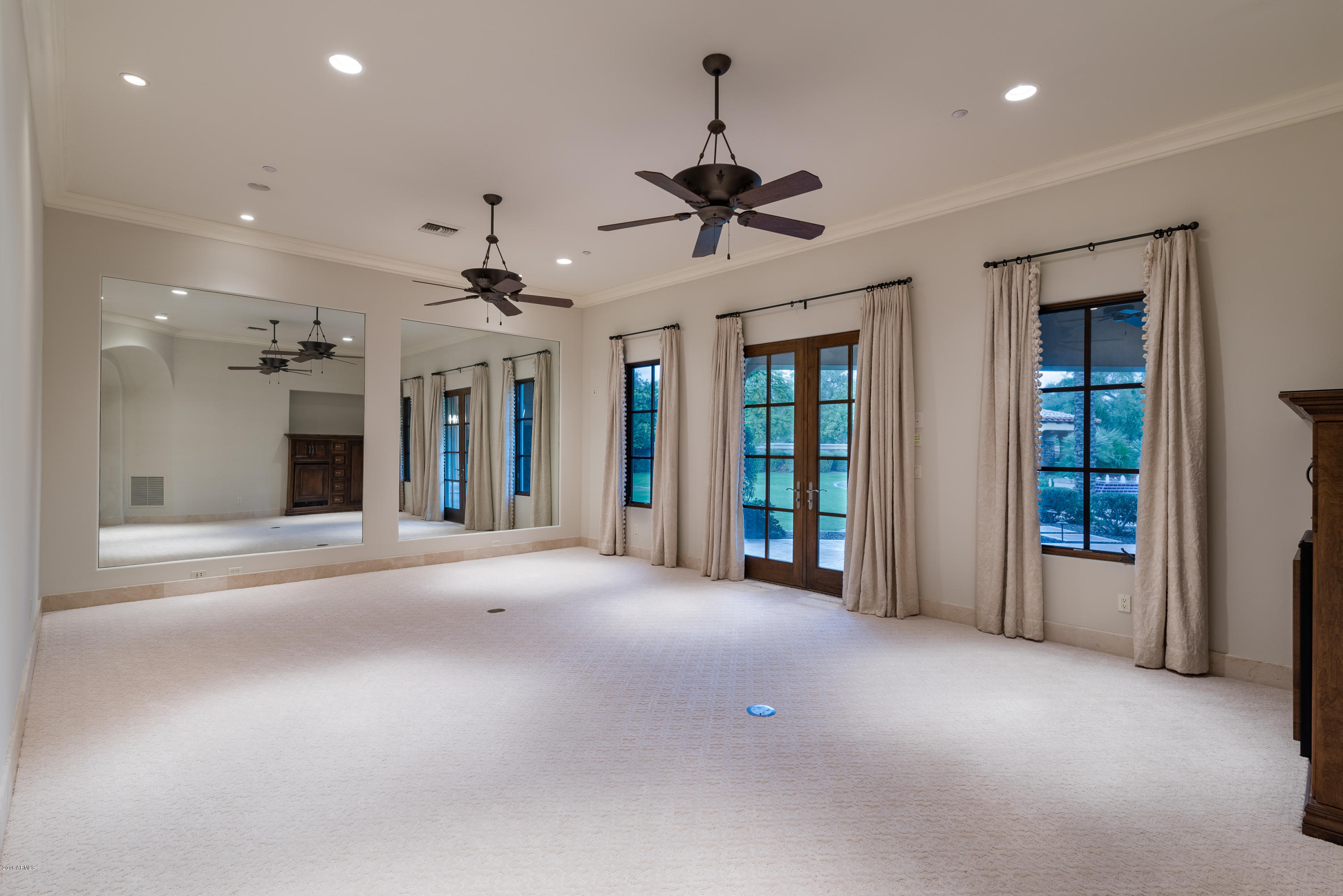 6390 East Royal Palm Road Paradise Valley, AZ 85253 - Photo 23 of 58 a view of a big room with a chandelier fan and windows