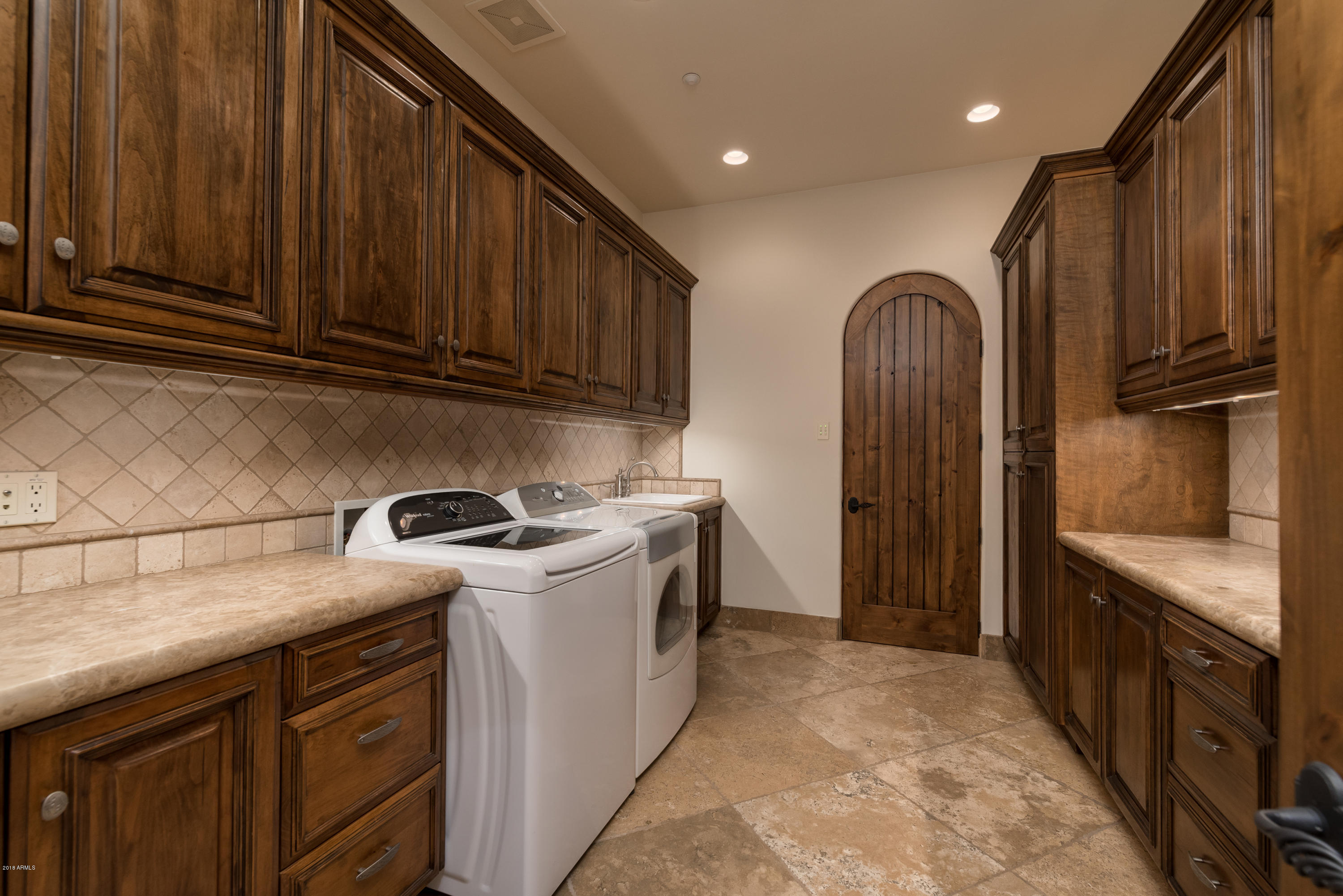 6390 East Royal Palm Road Paradise Valley, AZ 85253 - Photo 37 of 58 a kitchen with granite countertop a refrigerator stove and cabinets