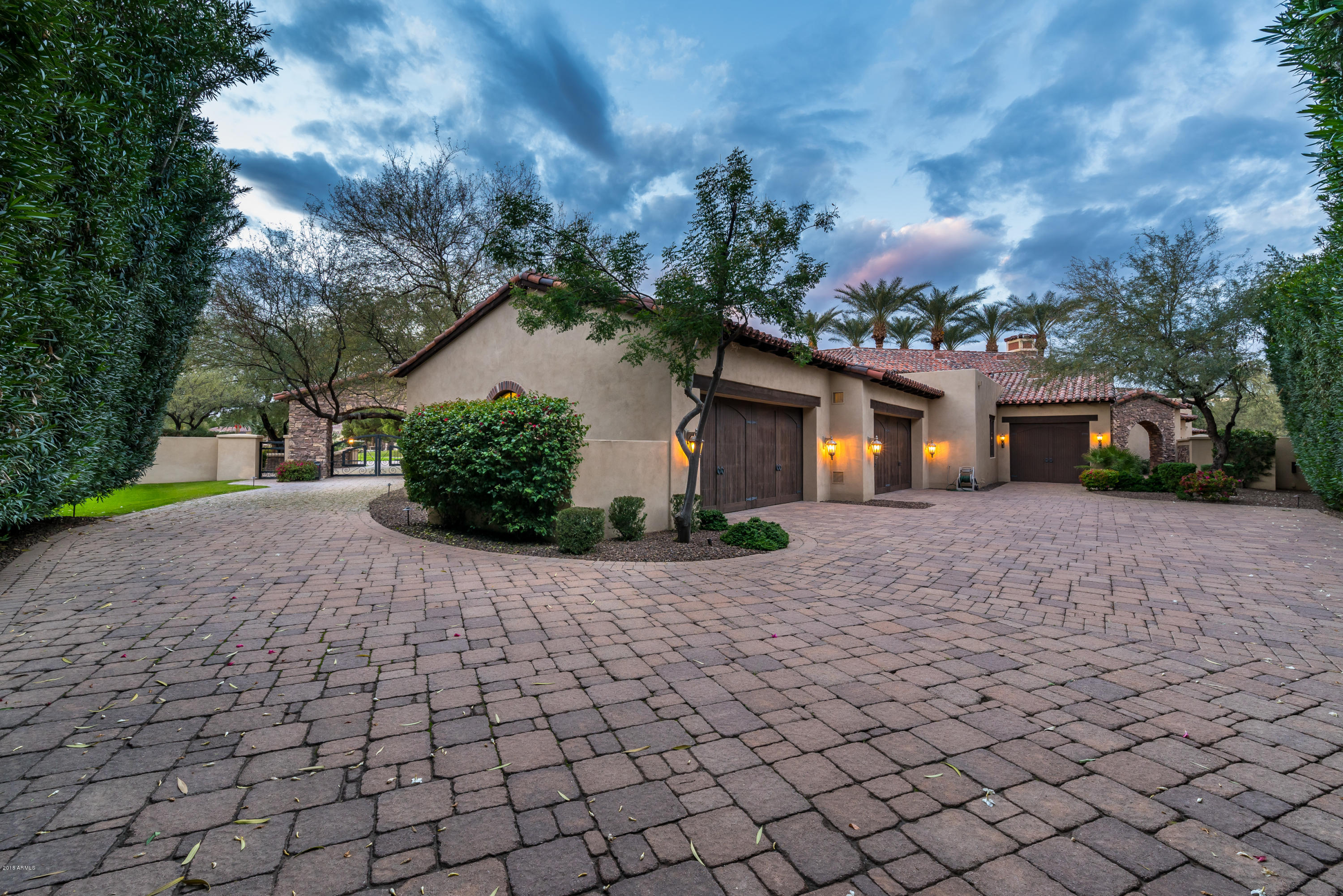 6390 East Royal Palm Road Paradise Valley, AZ 85253 - Photo 5 of 58 a front view of a house with a yard and a garage