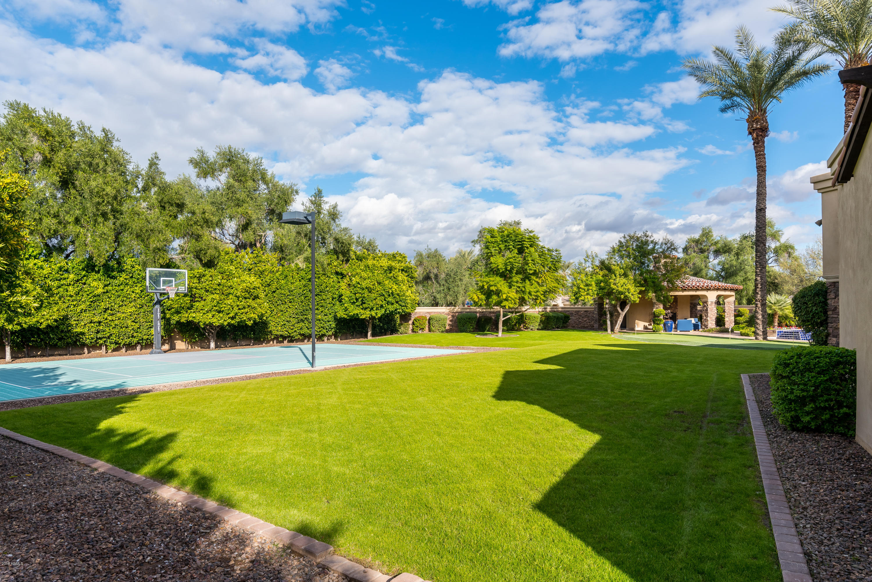 6390 East Royal Palm Road Paradise Valley, AZ 85253 - Photo 54 of 58 a view of a swimming pool and trees in the background