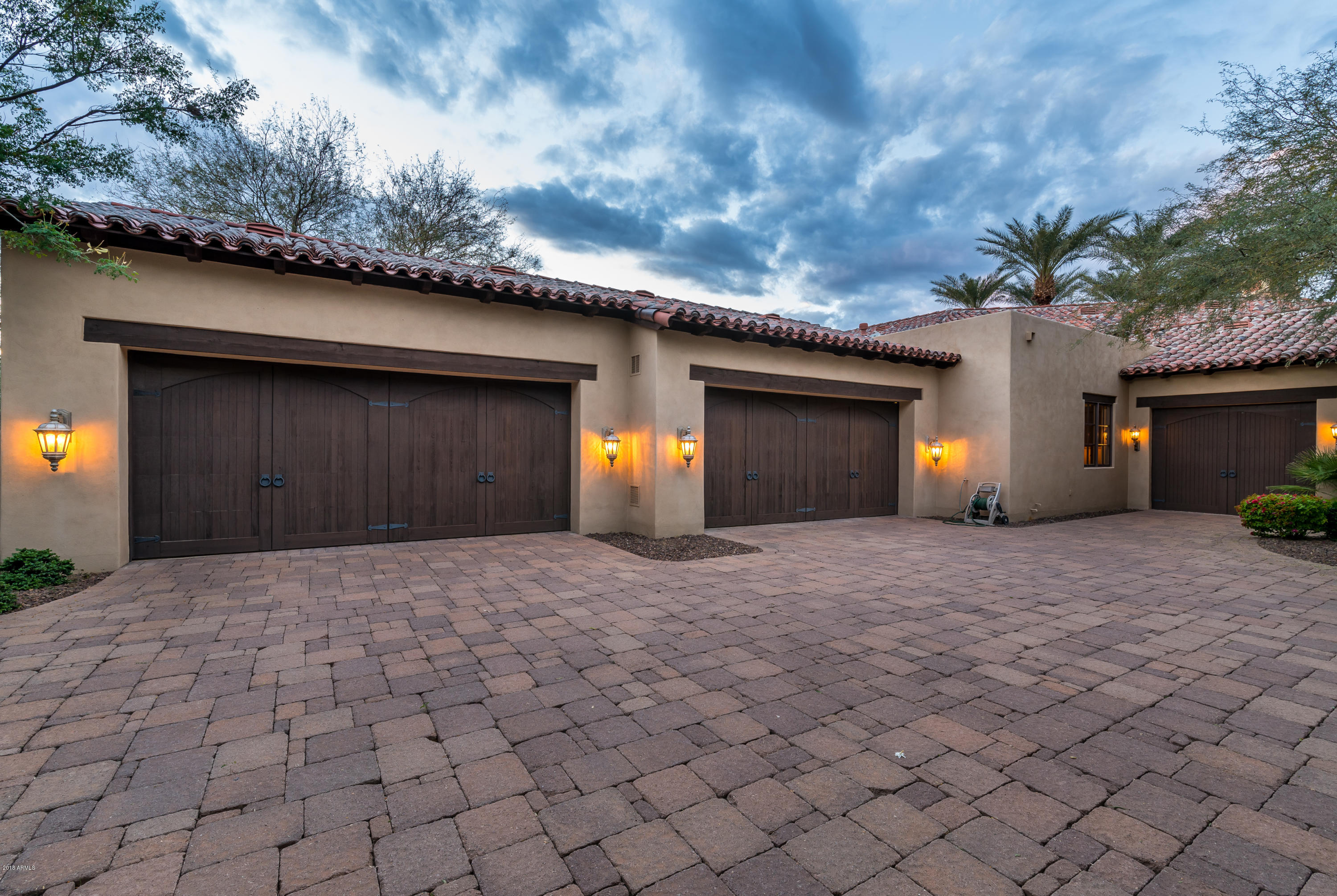 6390 East Royal Palm Road Paradise Valley, AZ 85253 - Photo 57 of 58 a front view of a house with a yard and garage