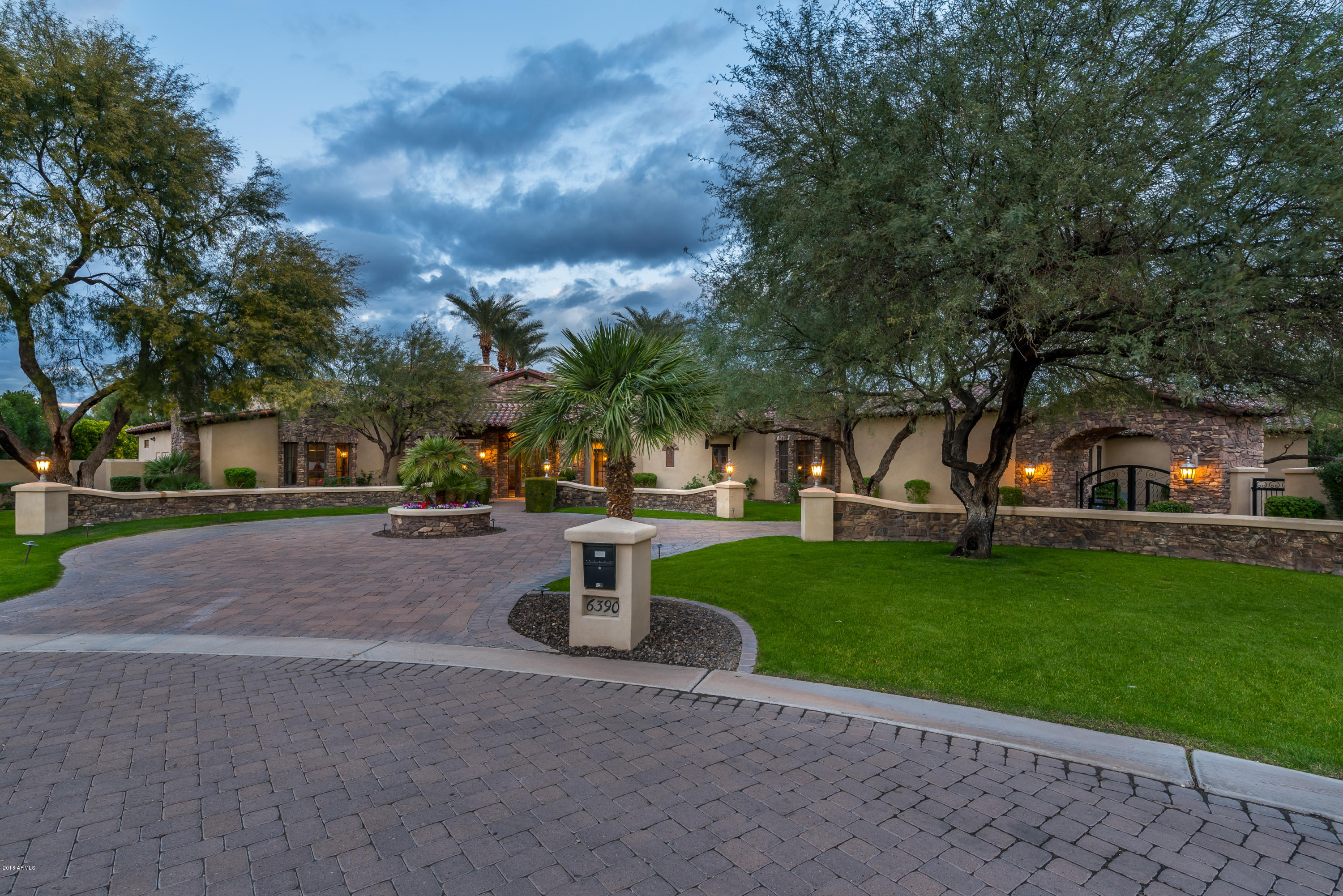 6390 East Royal Palm Road Paradise Valley, AZ 85253 - Photo 58 of 58 a view of a house with garden and a bench