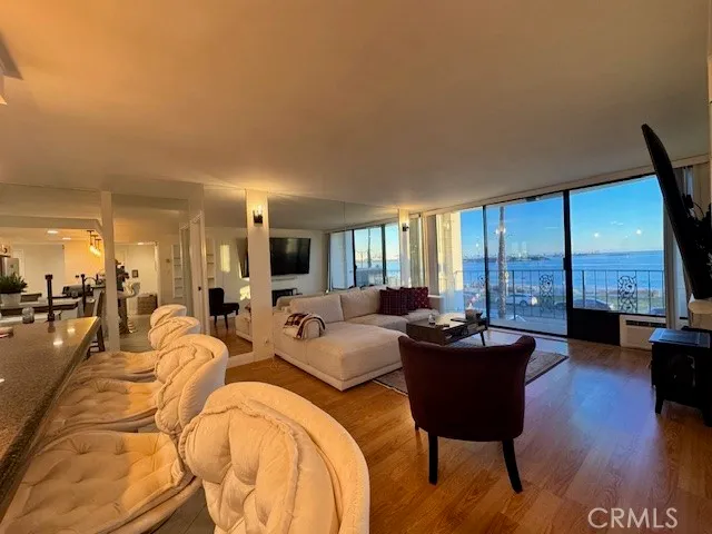 a living room with furniture and large windows