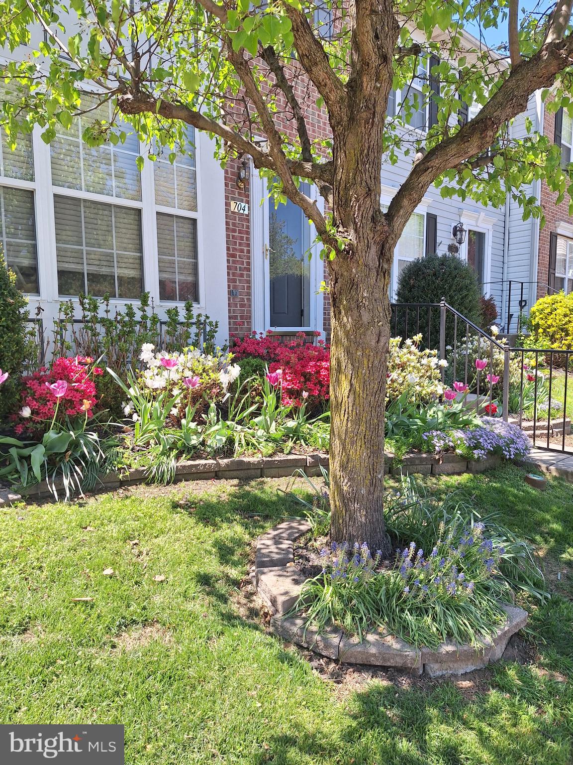 704 Shallow Ridge Court Abingdon, MD 21009 - Photo 3 of 6 a front view of a house with a yard and fountain in middle