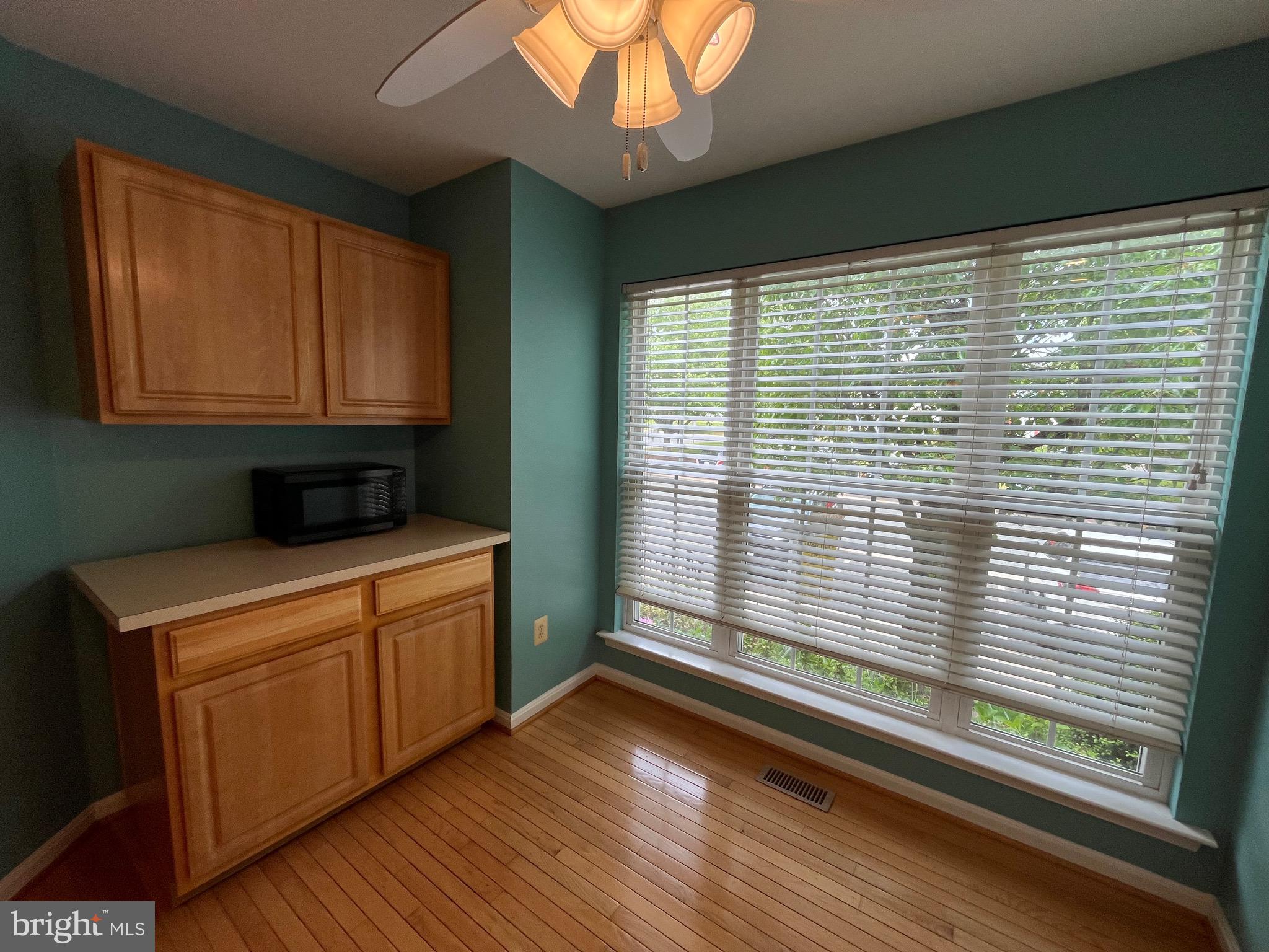 704 Shallow Ridge Court Abingdon, MD 21009 - Photo 4 of 41 a kitchen with a wooden floor and a large window