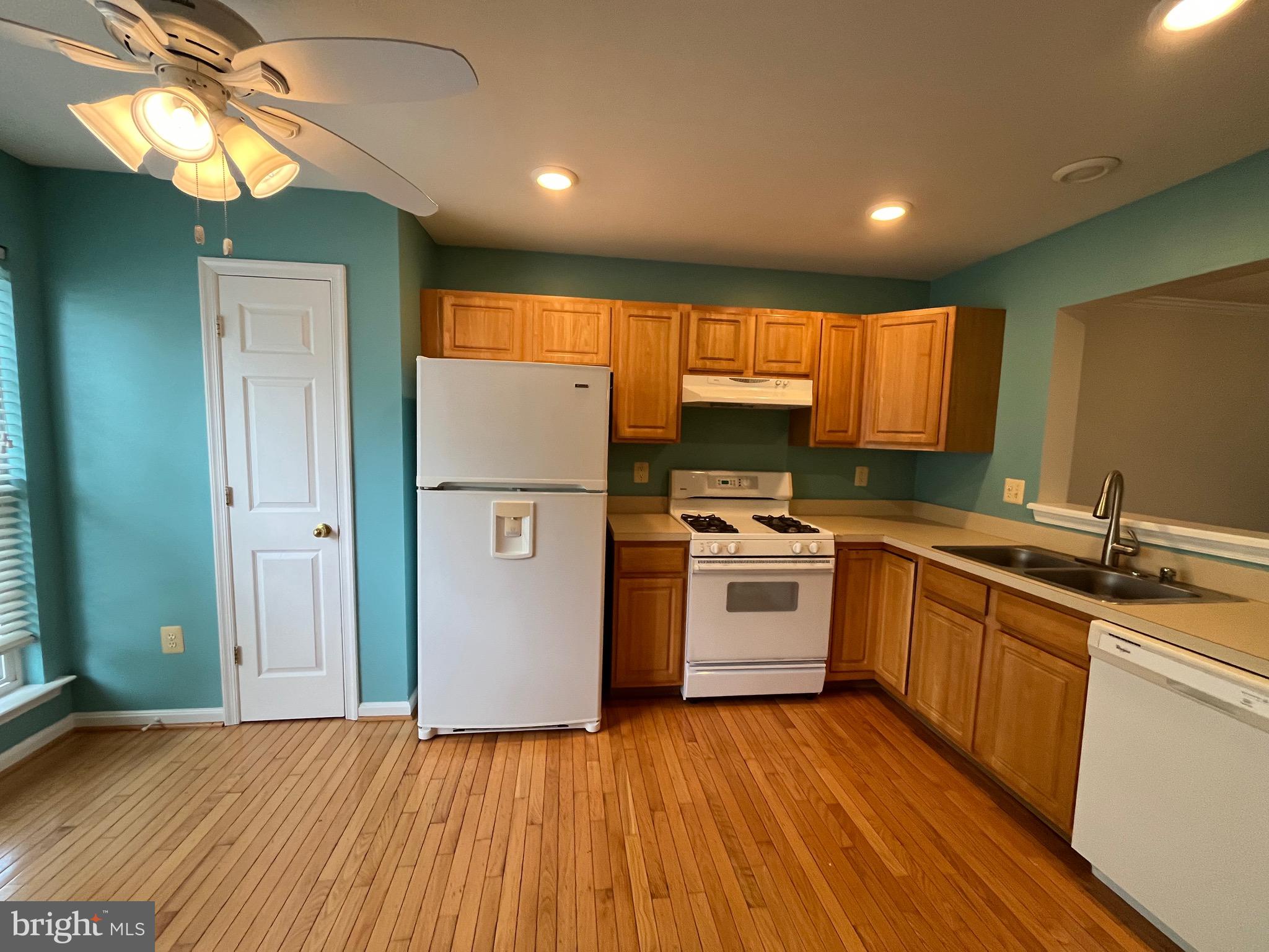 704 Shallow Ridge Court Abingdon, MD 21009 - Photo 5 of 41 a kitchen with a sink a refrigerator and cabinets