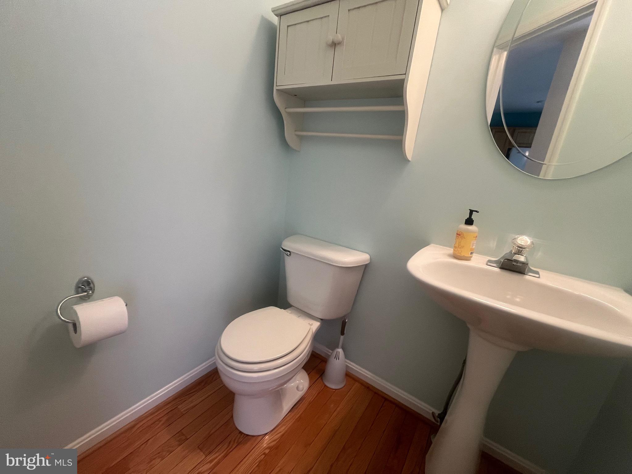 704 Shallow Ridge Court Abingdon, MD 21009 - Photo 8 of 41 a bathroom with a toilet a sink and mirror