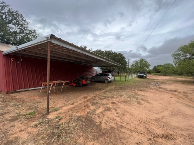 629 Elliott Road London, TX 76854 - Photo 25 of 49 a backyard of a house with a yard and garage