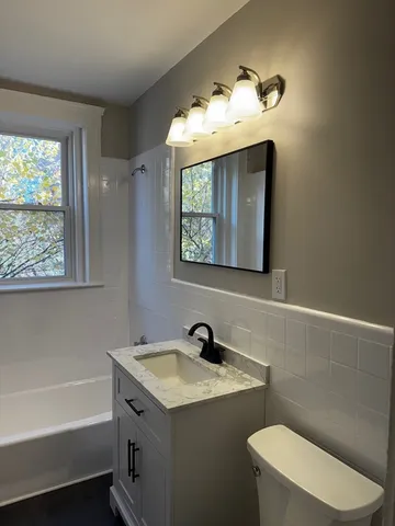 a bathroom with a sink a toilet and bathtub