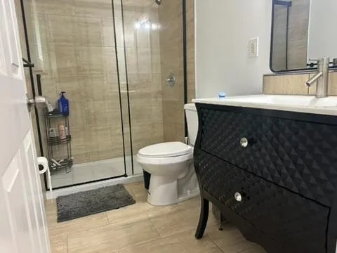 a bathroom with a shower and a toilet