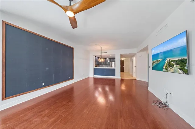 a view of an empty room with wooden floor