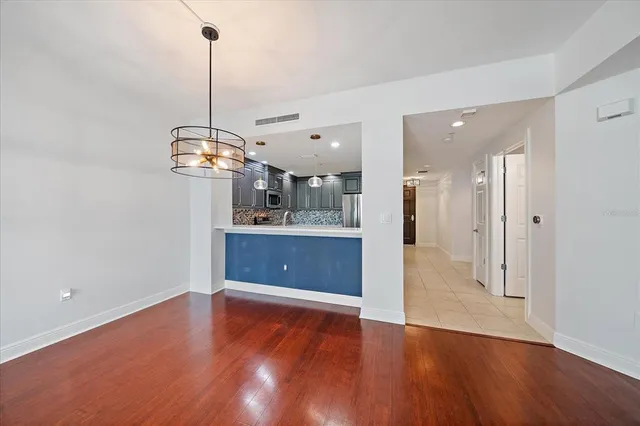 a view of a kitchen with a sink and wooden floor