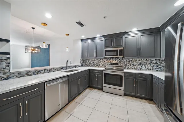 a large kitchen with cabinets and stainless steel appliances