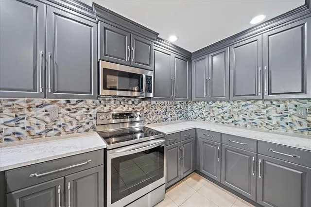 a kitchen with granite countertop cabinets stainless steel appliances and a sink