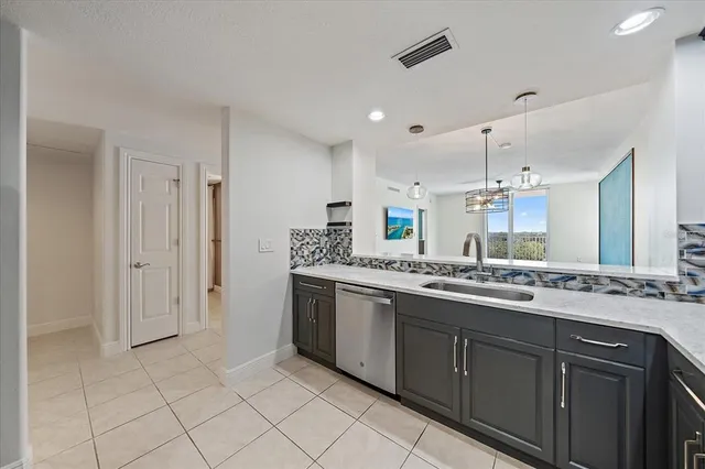 a large kitchen with a sink and cabinets