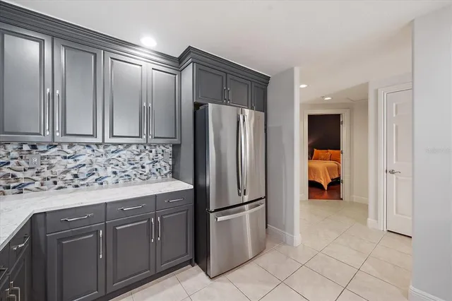 a kitchen with stainless steel appliances granite countertop a refrigerator and a sink