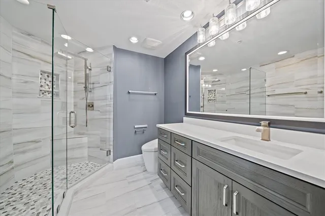 a bathroom with a shower sink and mirror