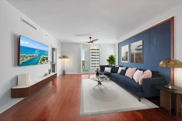 a living room with furniture and a wooden floor