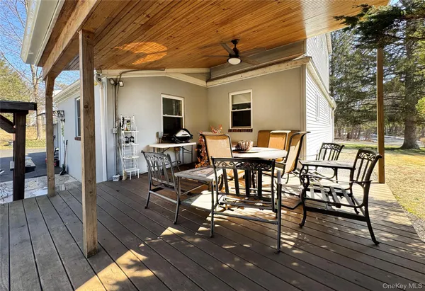 a view of a patio with table and chairs and wooden floor