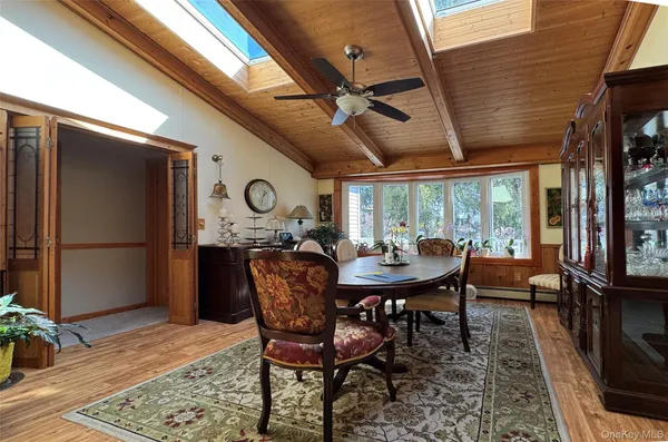 a dining room with furniture a rug a potted plant and a rug