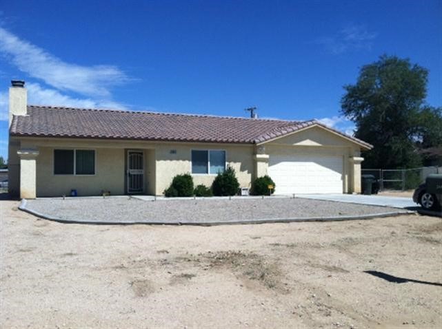20952 Pahute Road Apple Valley, CA 92308 - Photo 1 of 1 a view of a house with a yard and garage