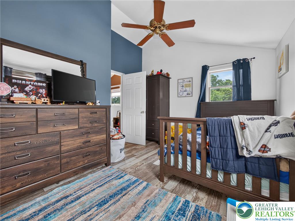 2628 Levans Road Coplay, PA 18037 - Photo 36 of 54 Vaulted ceilings elevate this naturally lit room, featuring robust wood flooring and a classic ceiling fan.