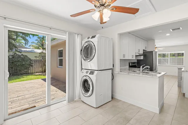a view of a kitchen with washing machine and a chandelier