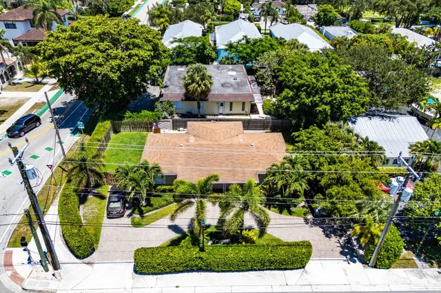an aerial view of a house with a yard and garden