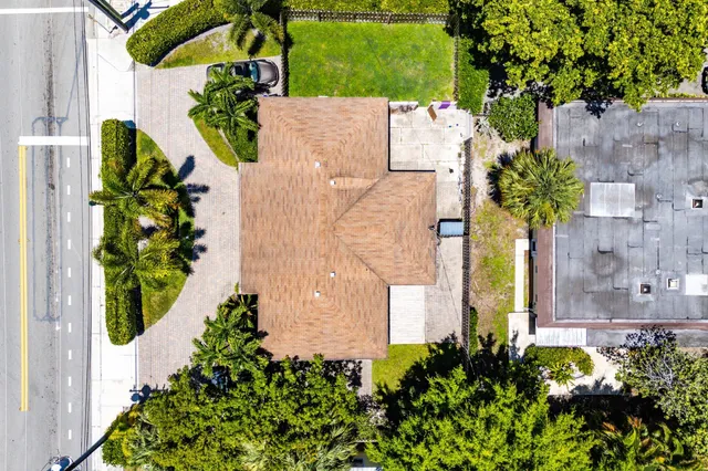 an aerial view of a house with a yard and garden