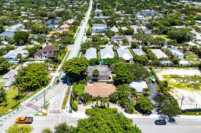 an aerial view of residential houses with outdoor space and trees all around