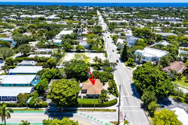 an aerial view of residential houses with outdoor space and trees