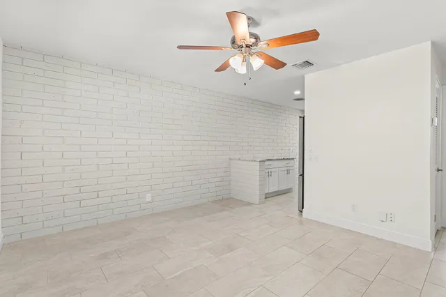 a view of a livingroom with a ceiling fan and window