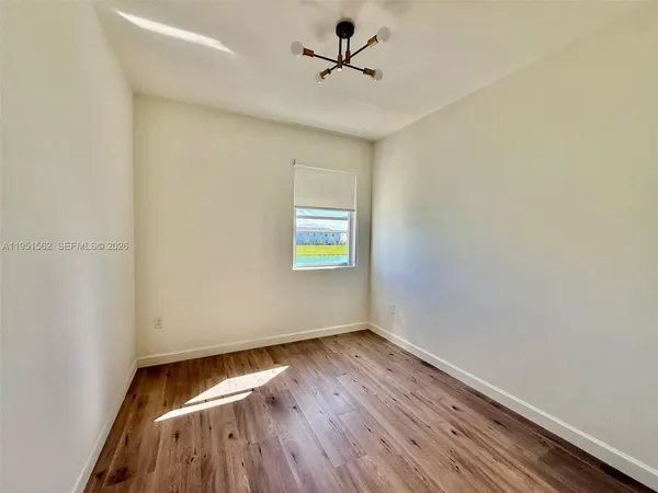 a view of hallway with wooden floor
