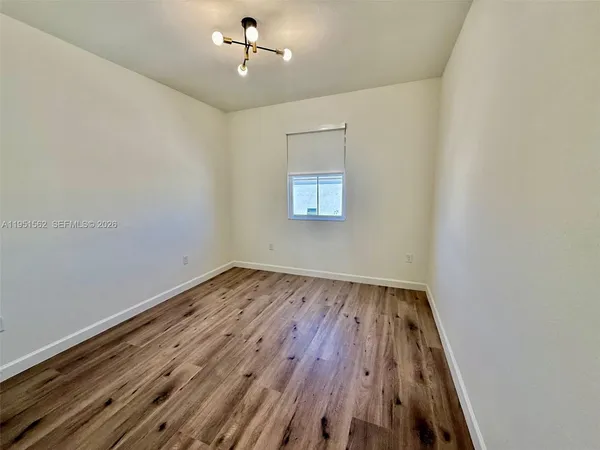 a view of a room with wooden floor