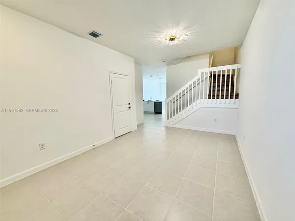 a view of staircase with white walls