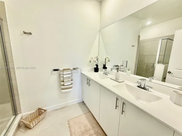 a bathroom with a double vanity sink a and mirror