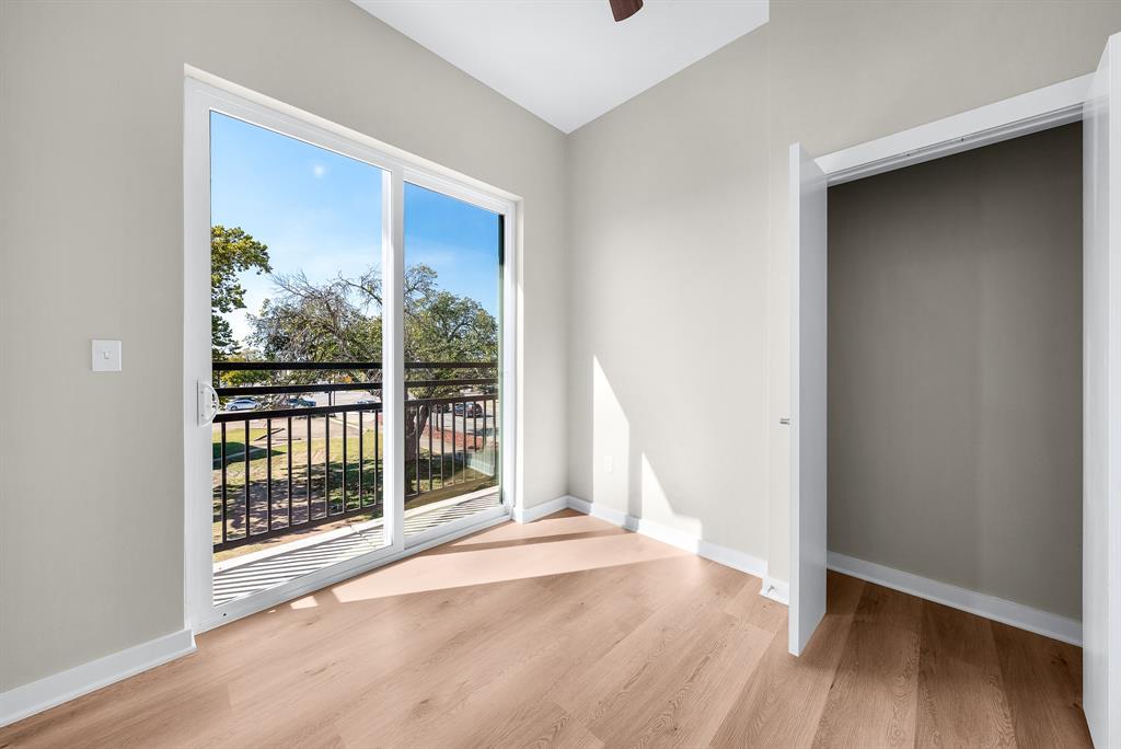 3522 Main Street, Unit 212 Rowlett, TX 75088 - Photo 8 of 25 a view of an empty room with wooden floor and a window