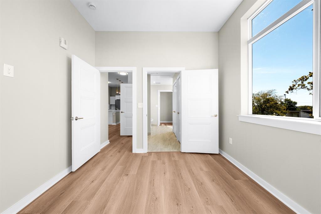 3522 Main Street, Unit 212 Rowlett, TX 75088 - Photo 11 of 25 a view of a room with wooden floor and a window