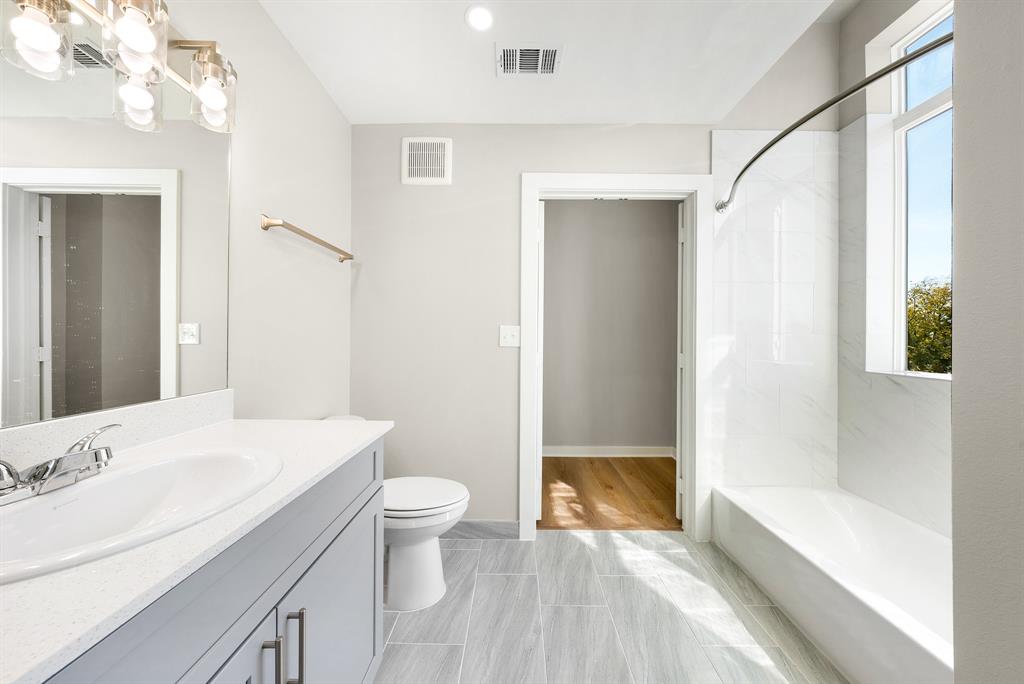 3522 Main Street, Unit 212 Rowlett, TX 75088 - Photo 12 of 25 a bathroom with a sink a toilet and shower