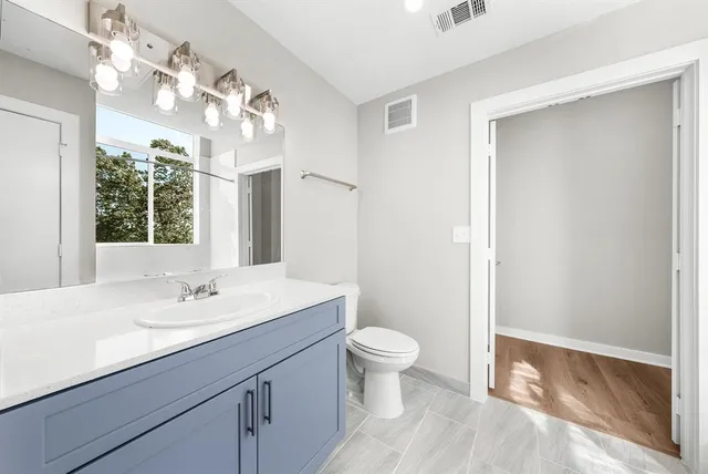 a view of a room with wooden floor and a window
