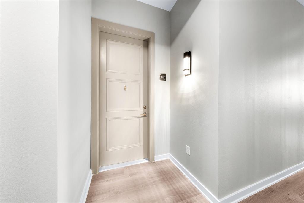 3522 Main Street, Unit 212 Rowlett, TX 75088 - Photo 17 of 25 a view of a hallway with wooden floor