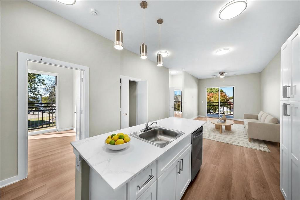 3522 Main Street, Unit 212 Rowlett, TX 75088 - Photo 24 of 25 a kitchen that has a sink a counter top space and living room area