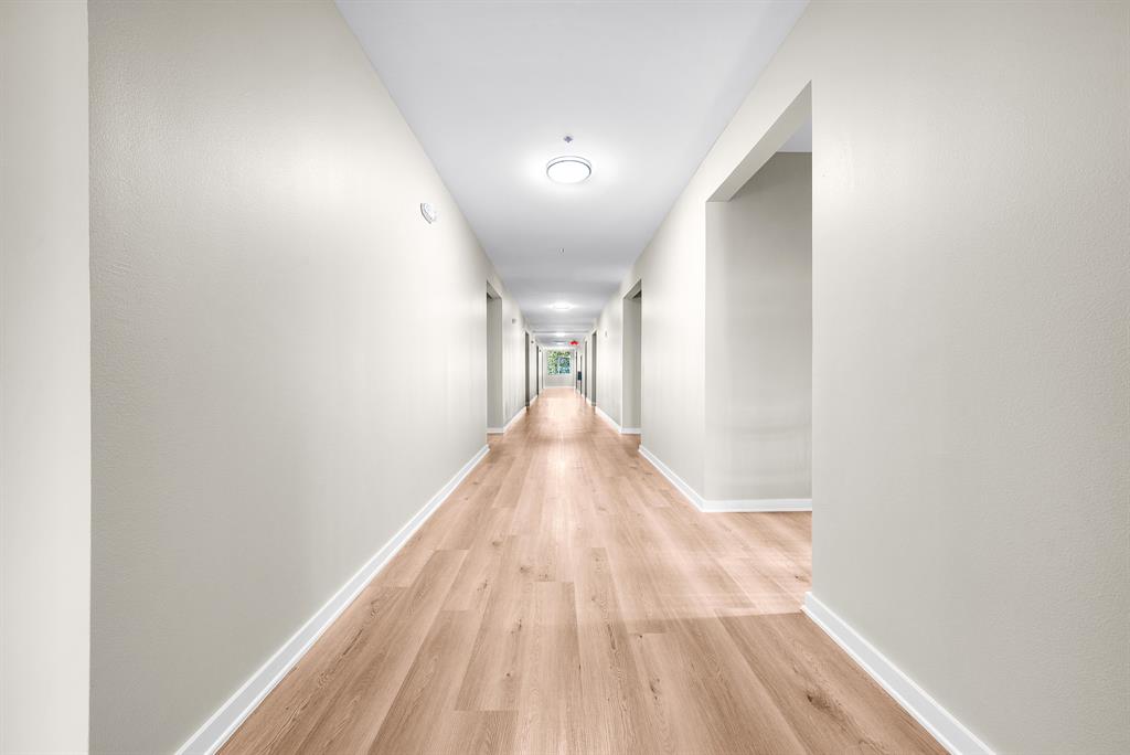 3522 Main Street, Unit 212 Rowlett, TX 75088 - Photo 18 of 25 a view of a hallway with wooden floor