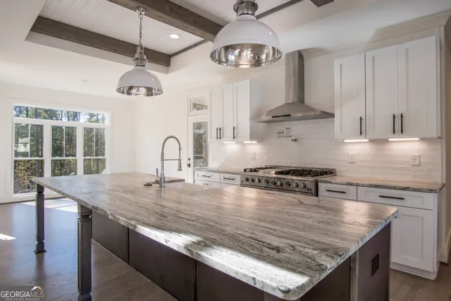 a kitchen with stainless steel appliances granite countertop a stove a refrigerator and a granite counter tops