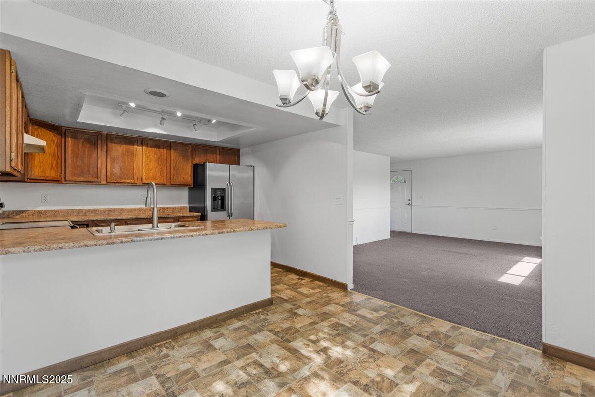 1090 Hartford Court Reno, NV 89503 - Photo 11 of 45 a view of a kitchen with a sink and chandelier
