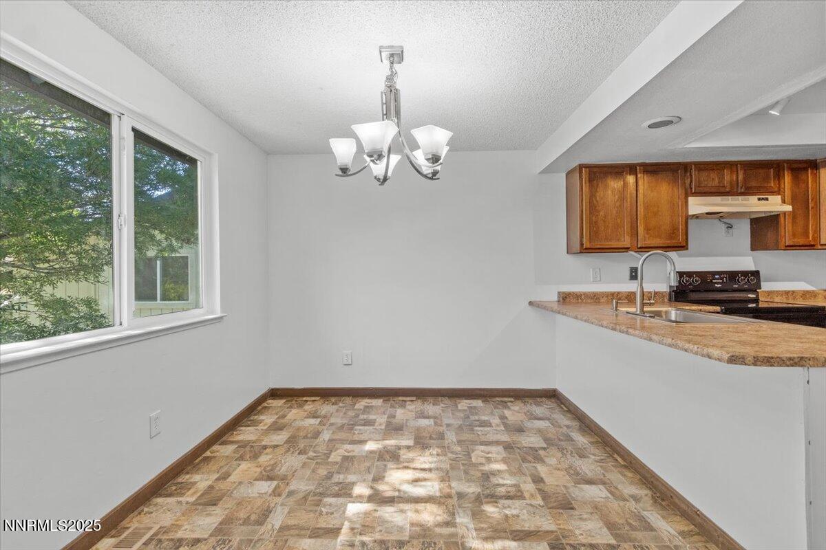 1090 Hartford Court Reno, NV 89503 - Photo 12 of 45 a view of a kitchen with a sink dishwasher a fireplace with wooden floor