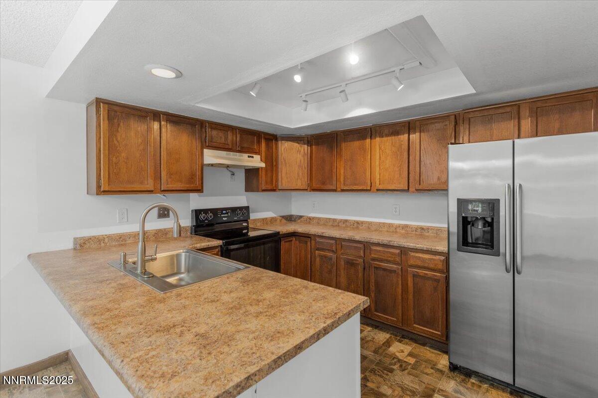 1090 Hartford Court Reno, NV 89503 - Photo 14 of 45 a kitchen with stainless steel appliances granite countertop a sink stove and refrigerator