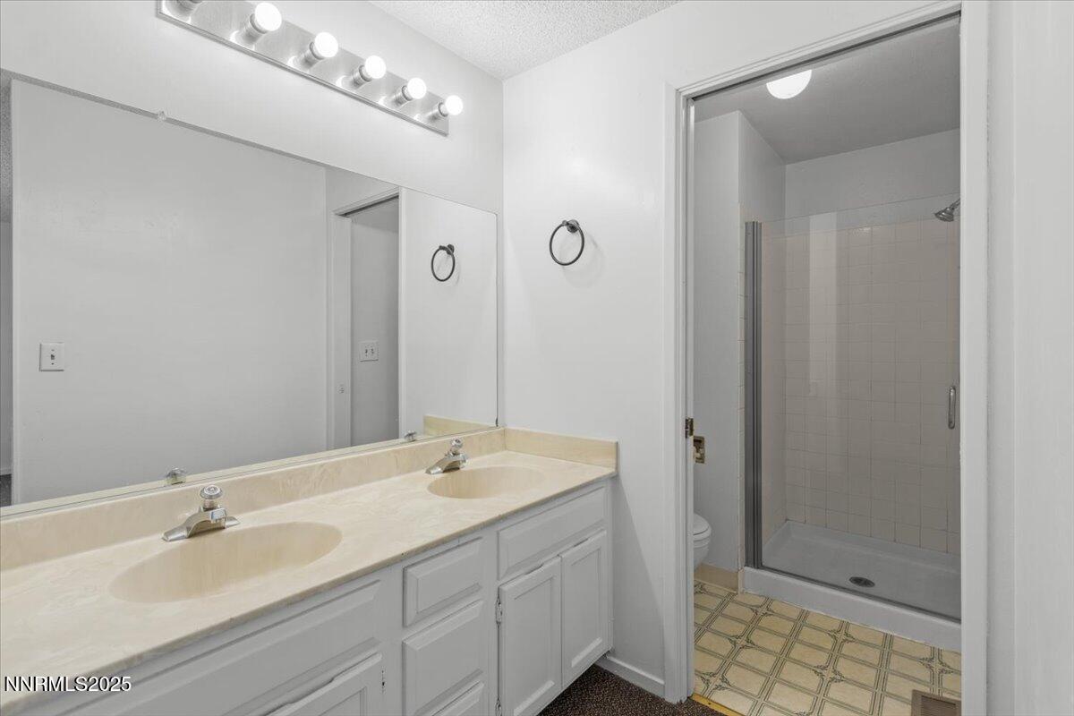 1090 Hartford Court Reno, NV 89503 - Photo 18 of 45 a bathroom with a double vanity sink mirror and shower