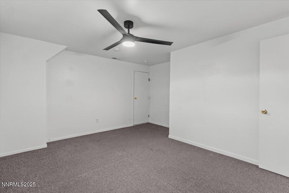 1090 Hartford Court Reno, NV 89503 - Photo 24 of 45 an empty room with a ceiling fan and a window